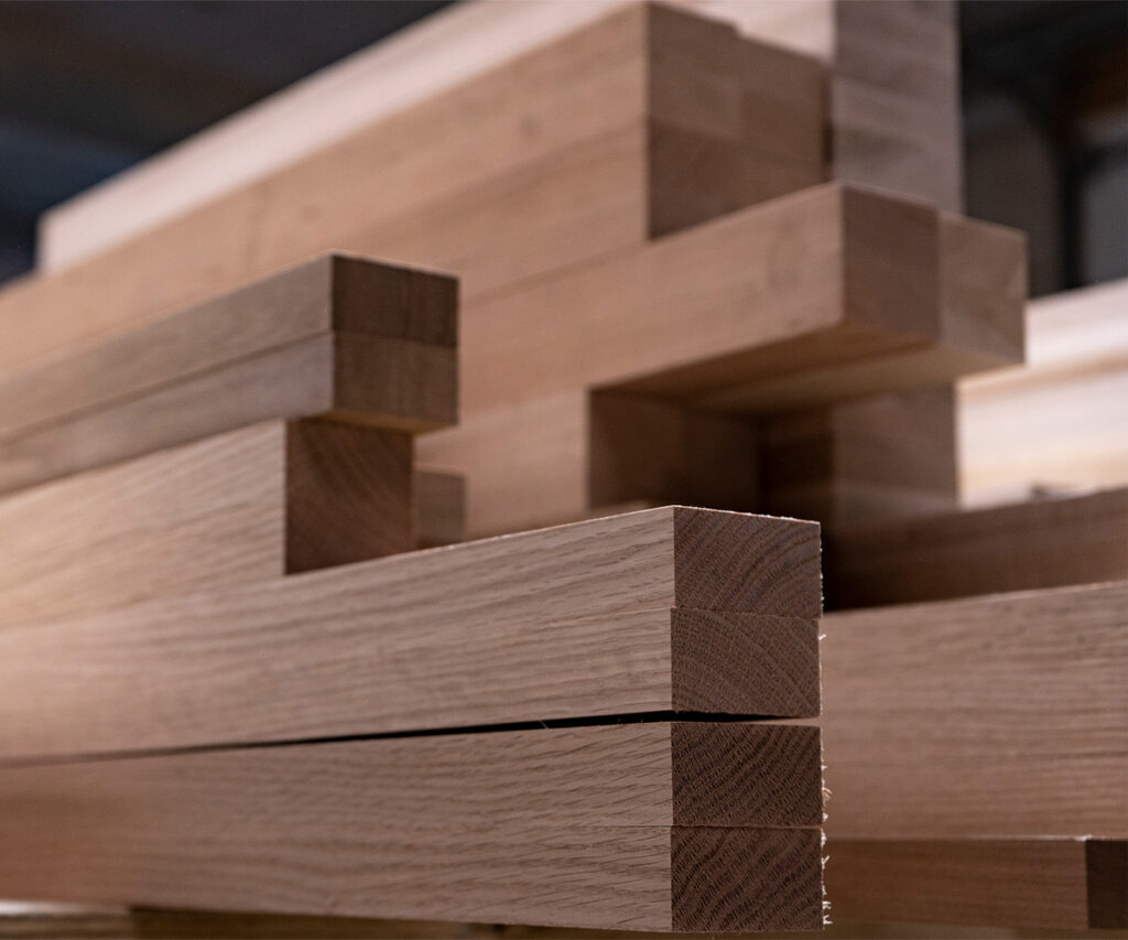 Stacked North American hardwood boards prepared for Amish furniture craftsmanship.