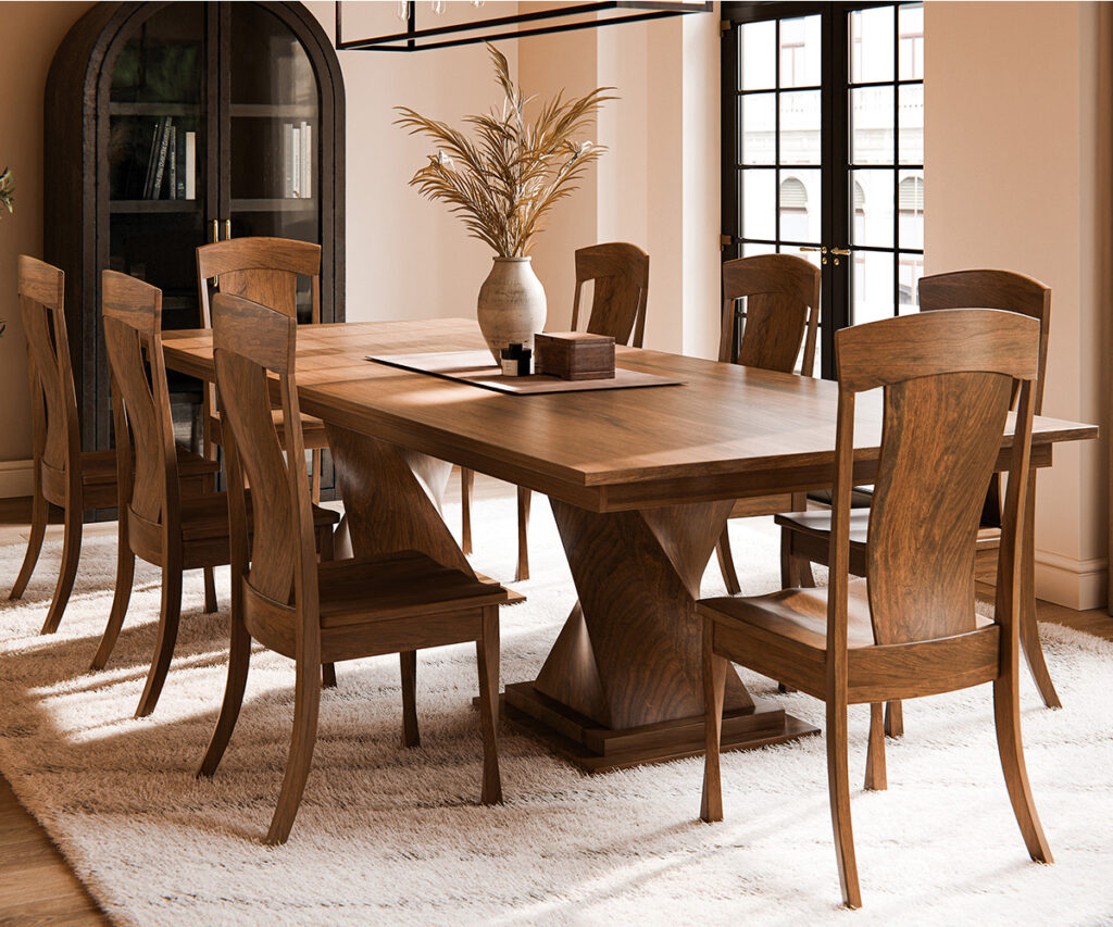 Solid wood dining table with matching chairs in a warm, elegant dining room.